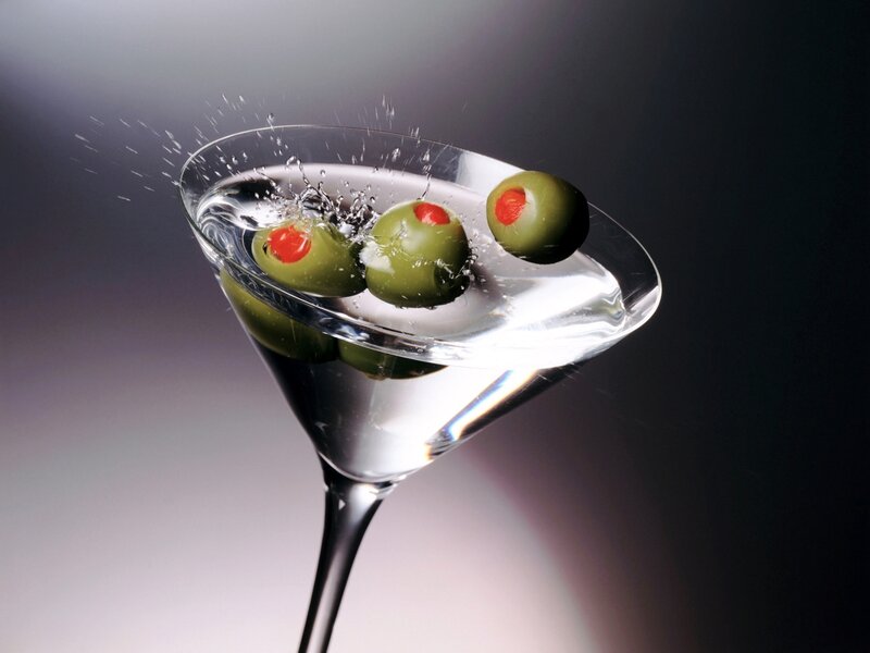olives splashing in martini