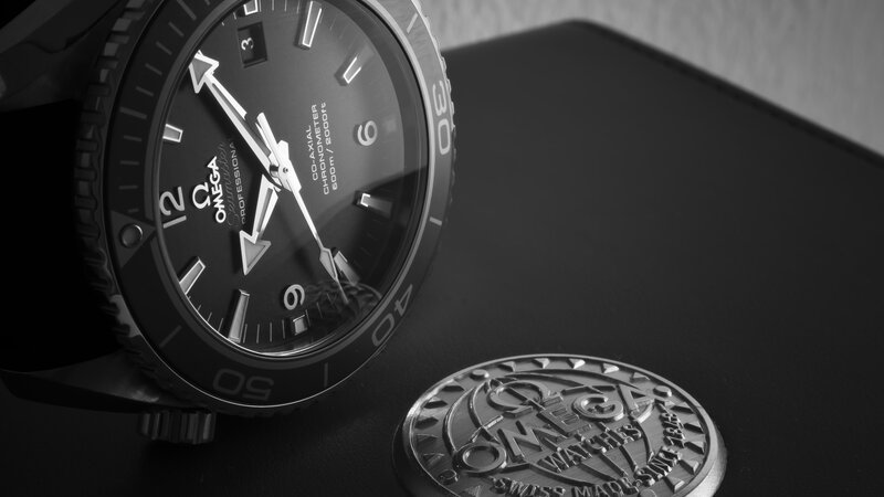 Omega Seamaster Watch — Black, Dramatic, Photograph, Coin