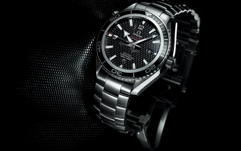 Omega Watch on Black Surface — Dramatic, Photograph