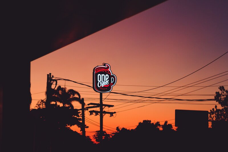 One Coffee sign at sunset
