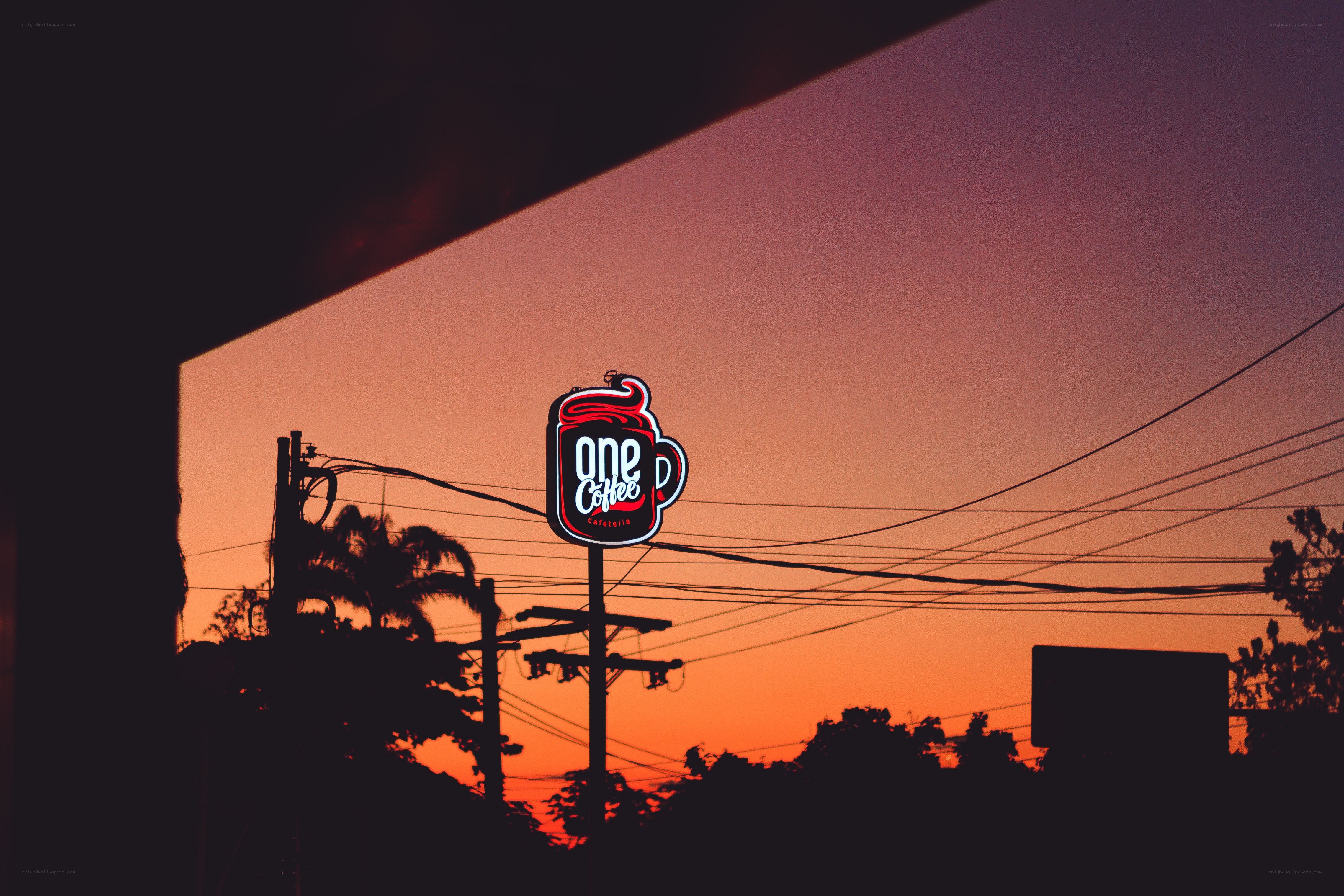 One Coffee sign at sunset