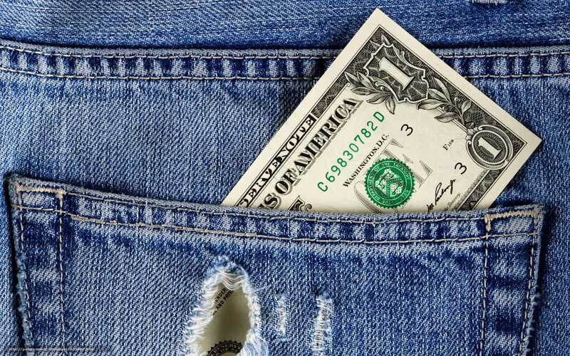 One dollar bill in jeans pocket