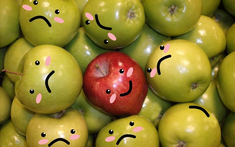 one happy apple among sad green apples
