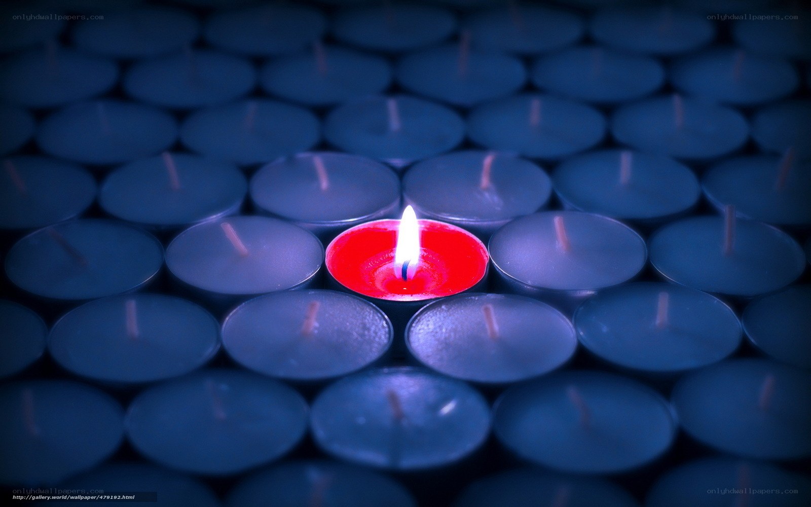 One red candle among blue