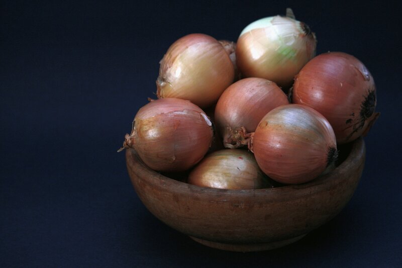 Onions in a wooden bowl