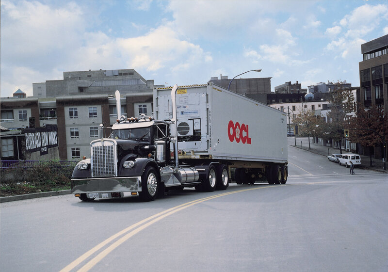 OOCL refrigerated truck on city street