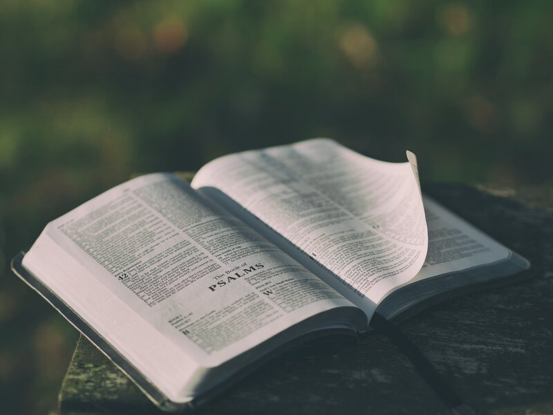 open bible on stone surface