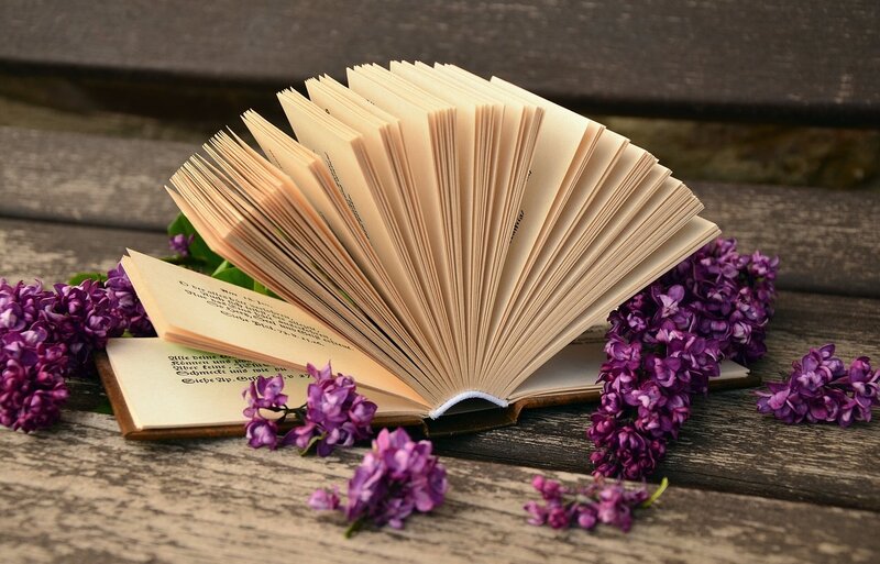 Open Book with Flowers — Purple, Serene, Spring, Photograph, Wooden Surface