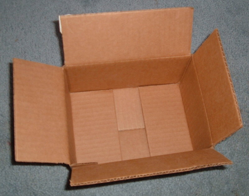 open cardboard box on carpet