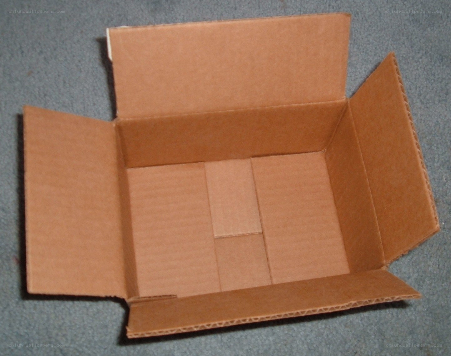 open cardboard box on carpet