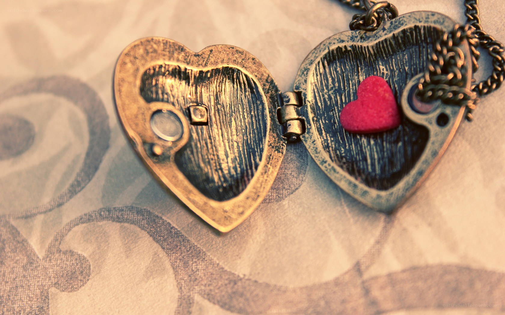 open heart locket with red charm