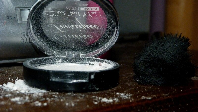 open makeup compact on table