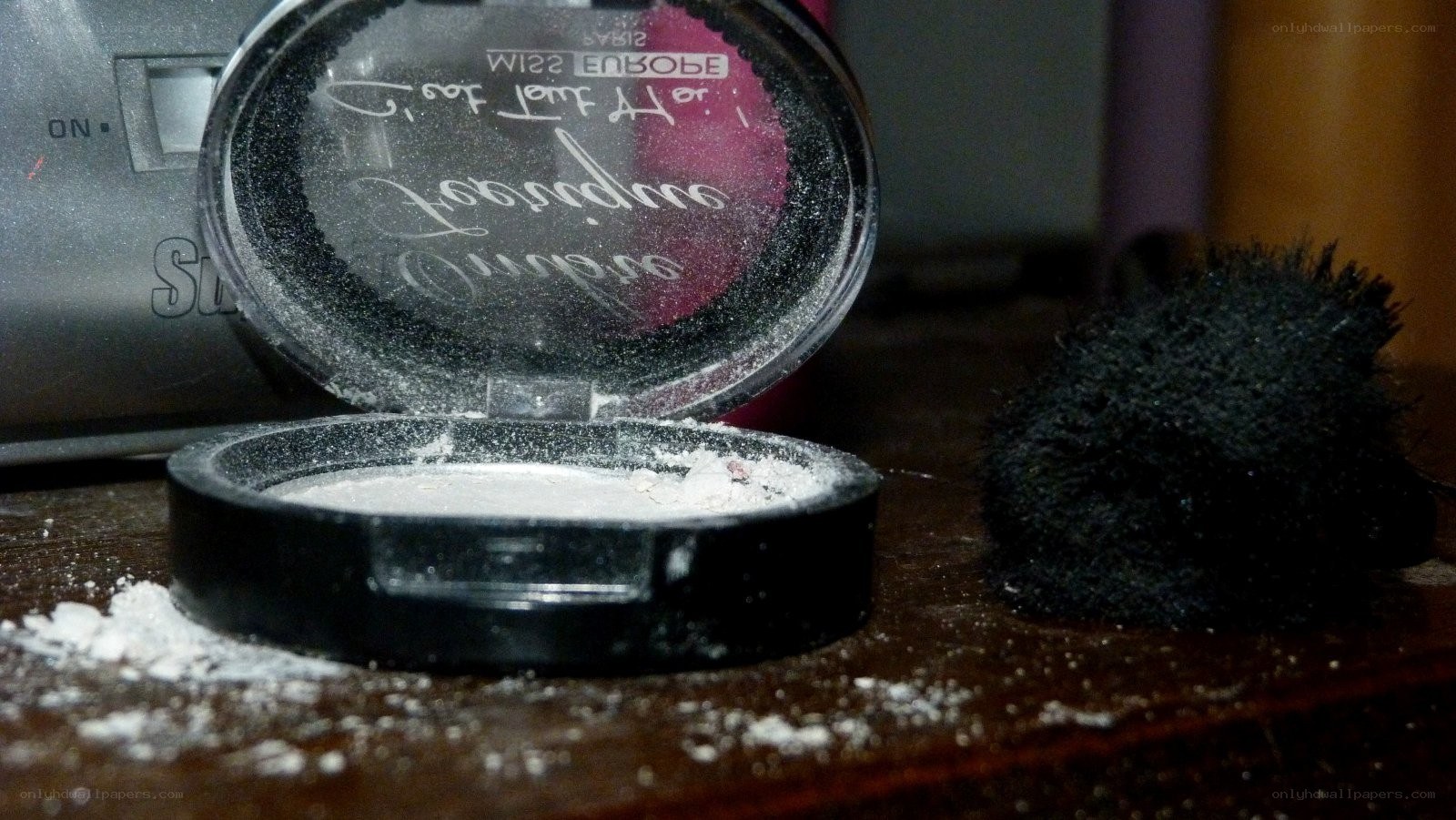 open makeup compact on table
