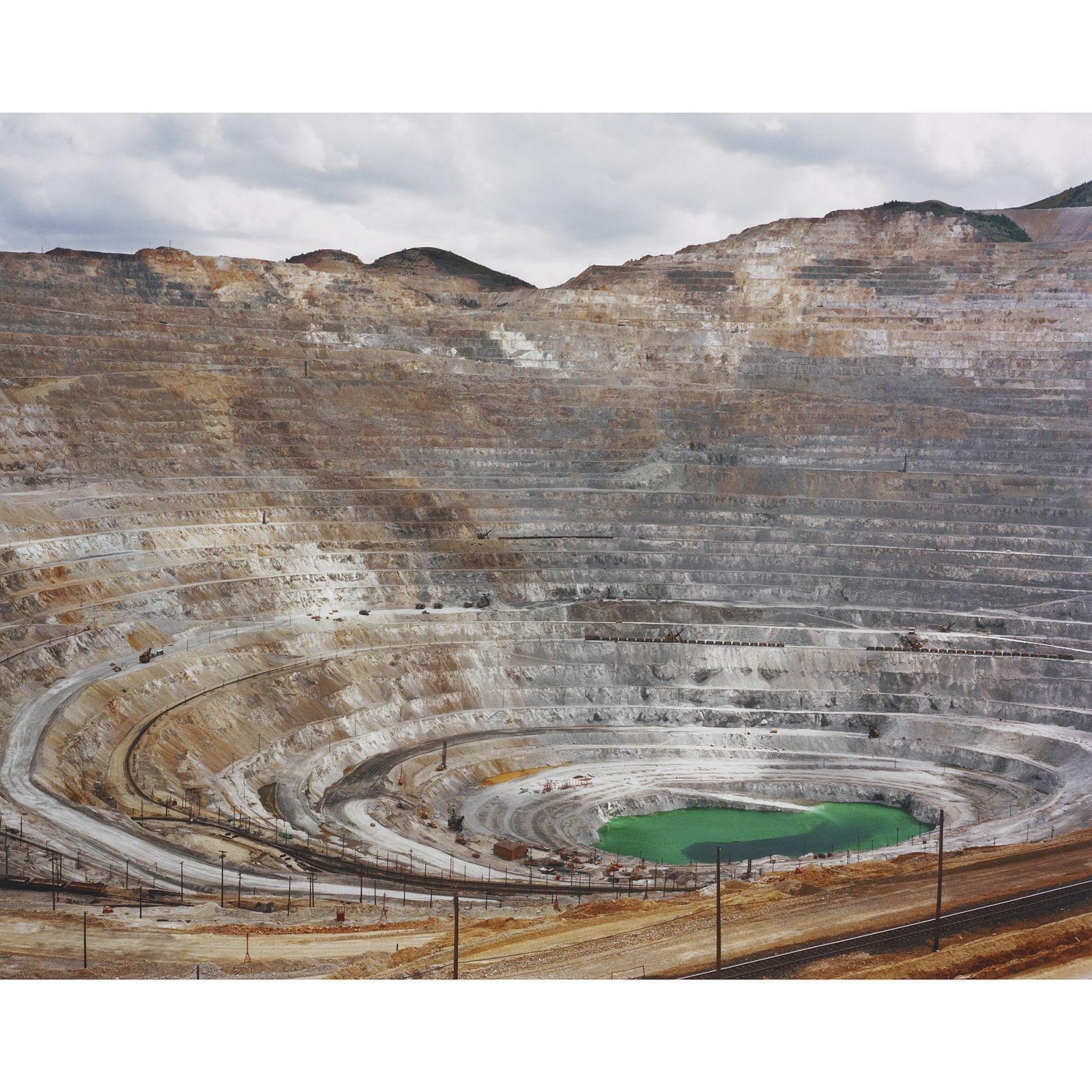 Open-pit mine with green pond