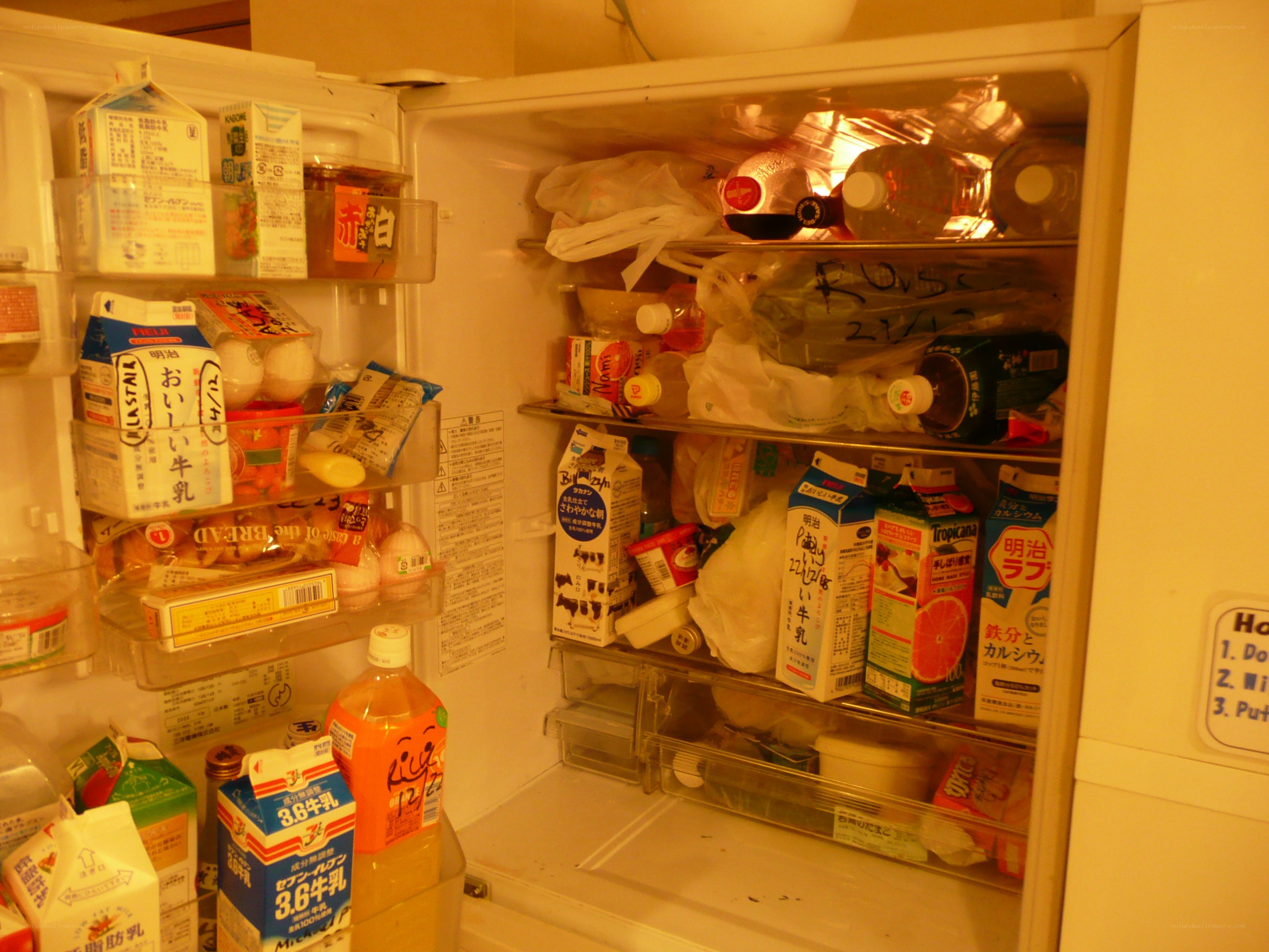 open refrigerator with milk and drinks
