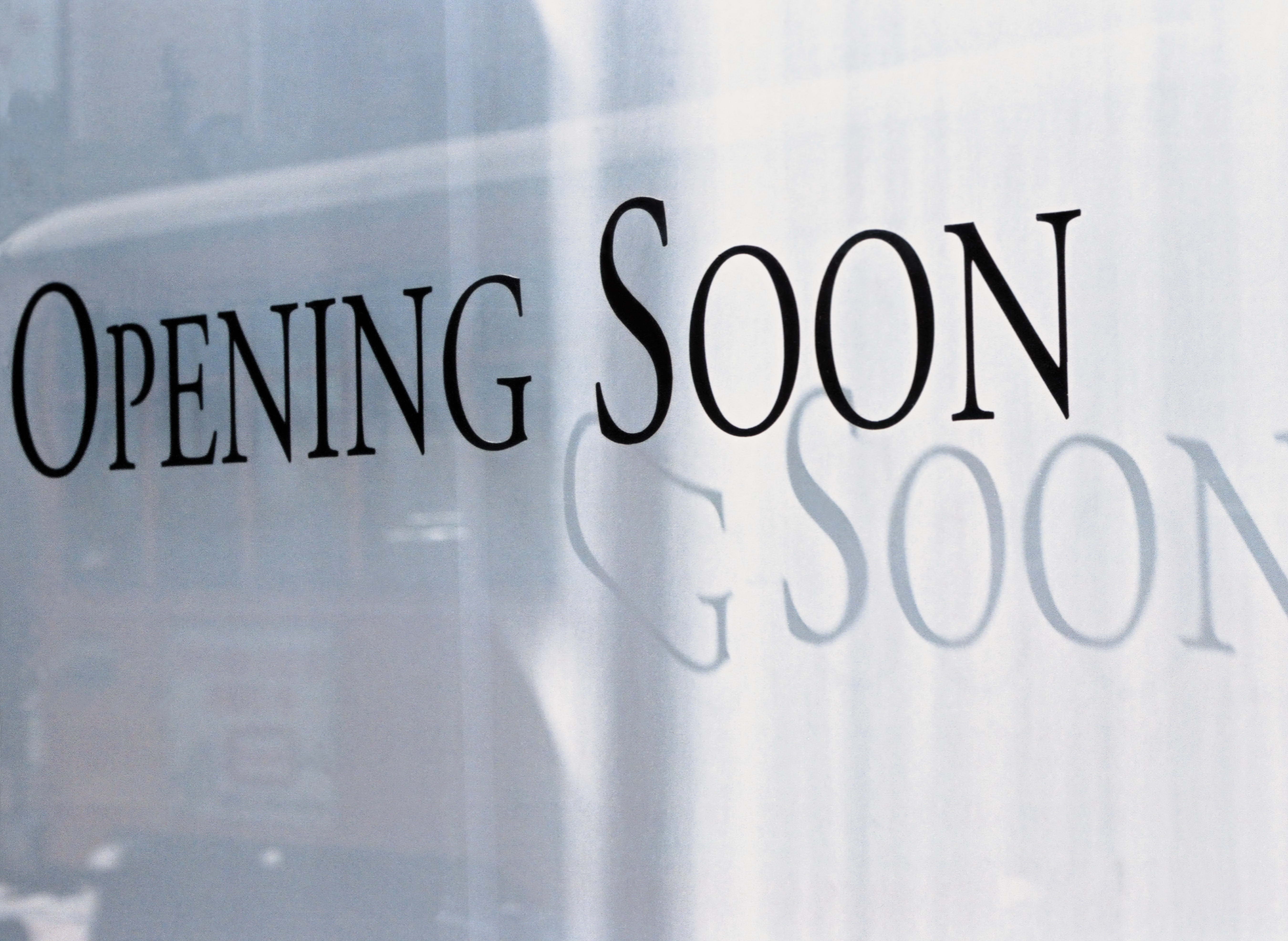 Opening Soon sign on glass