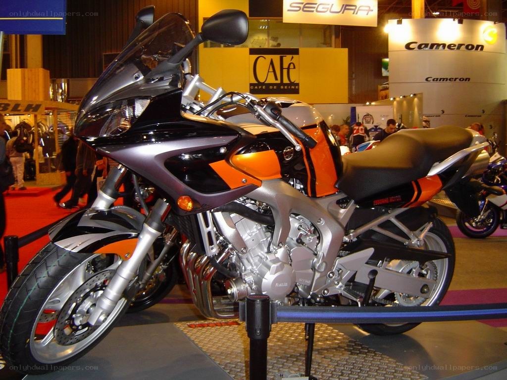 orange and black motorcycle on display
