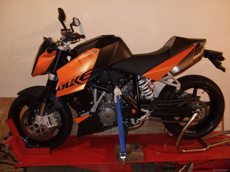 orange and black motorcycle on lift