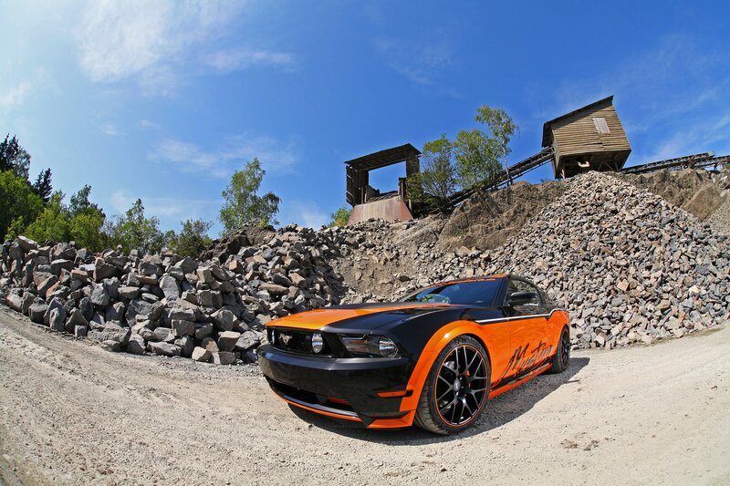 Orange and black Mustang in quarry
