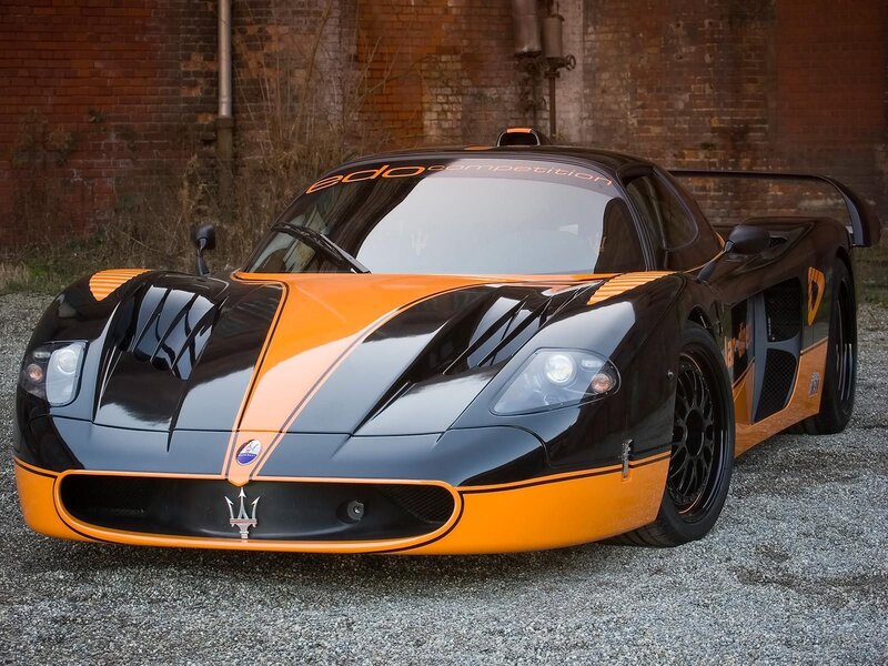 Orange and Black Race Car — Dramatic, Photograph, Brick Wall