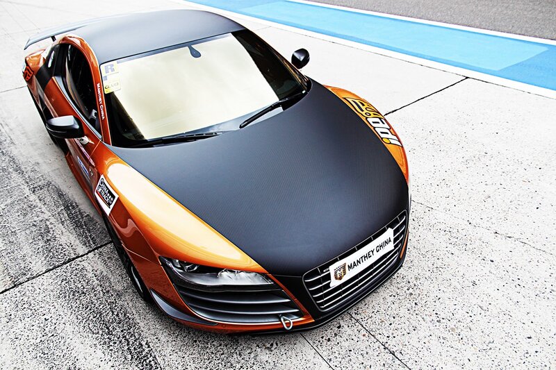 Orange and black race car on track