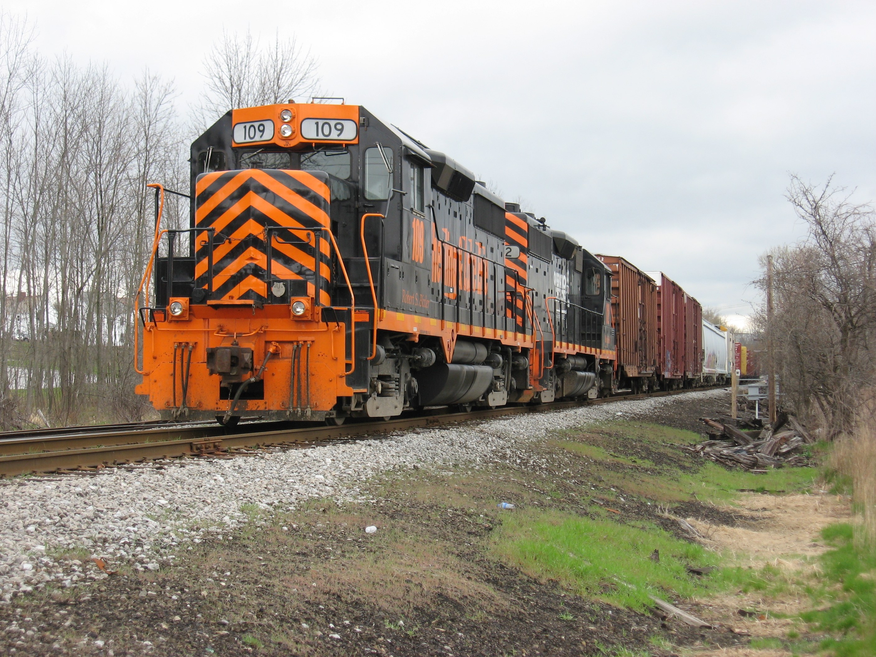 orange and black train on tracks