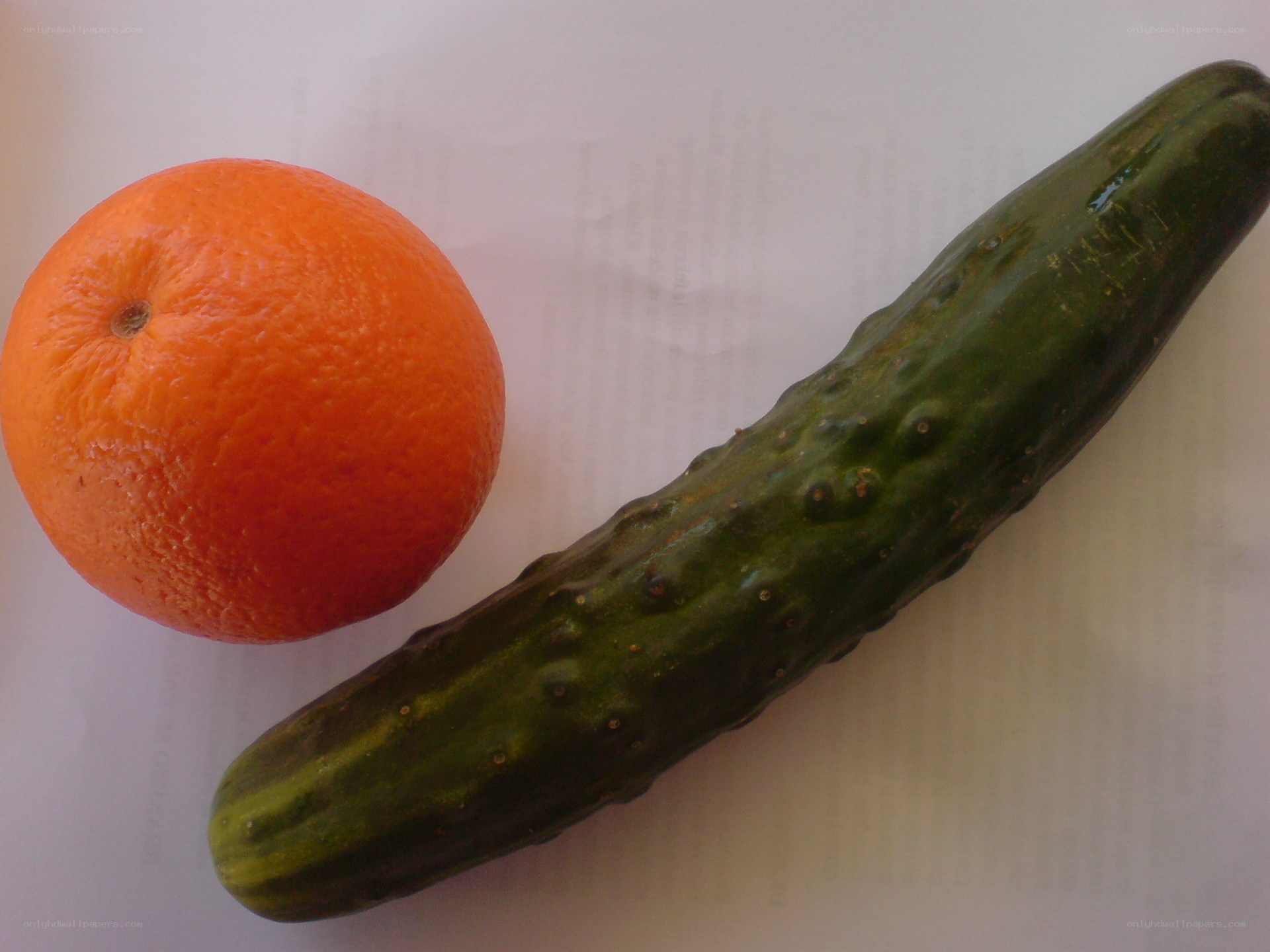 orange and cucumber on paper