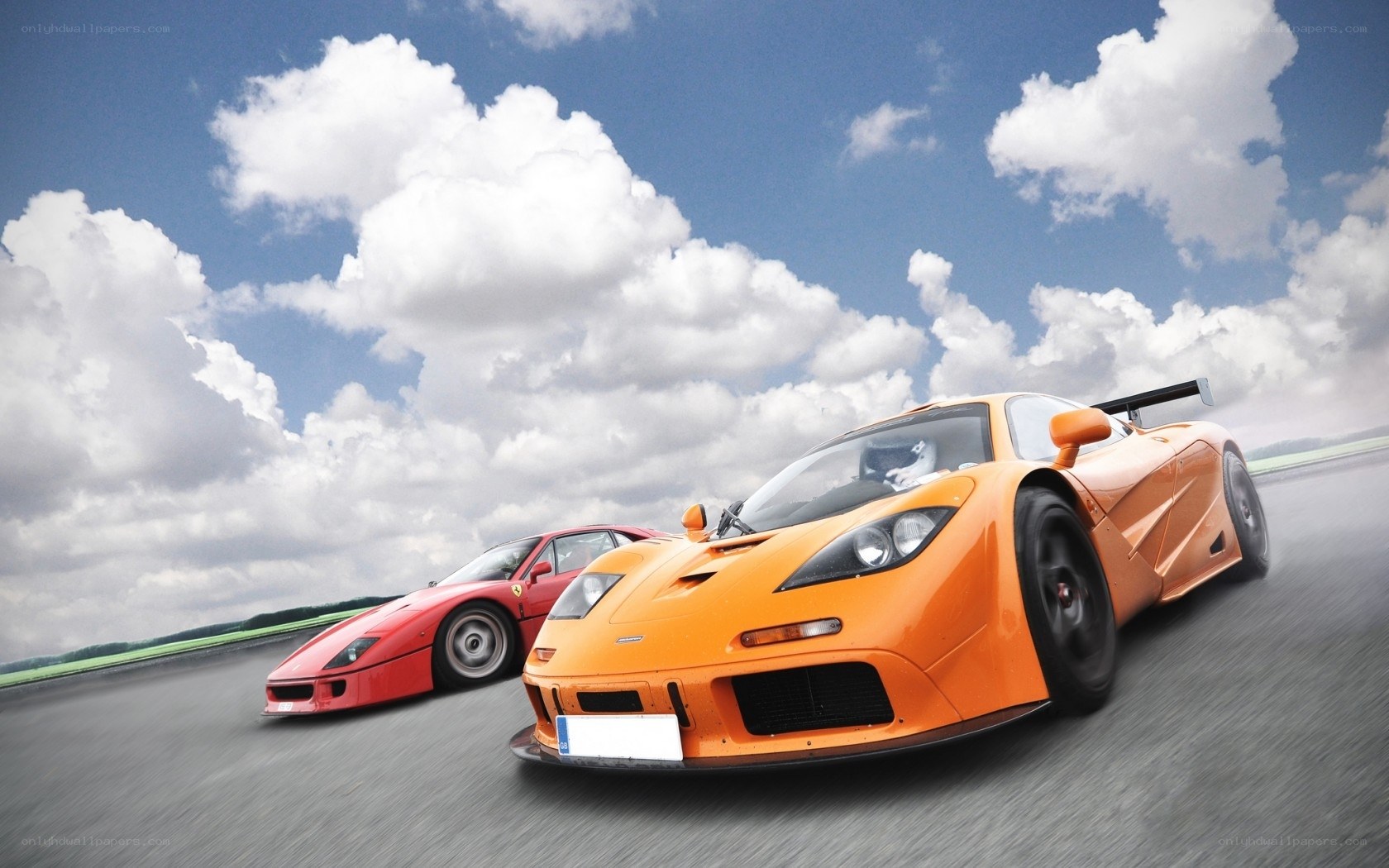 Orange and red sports cars racing