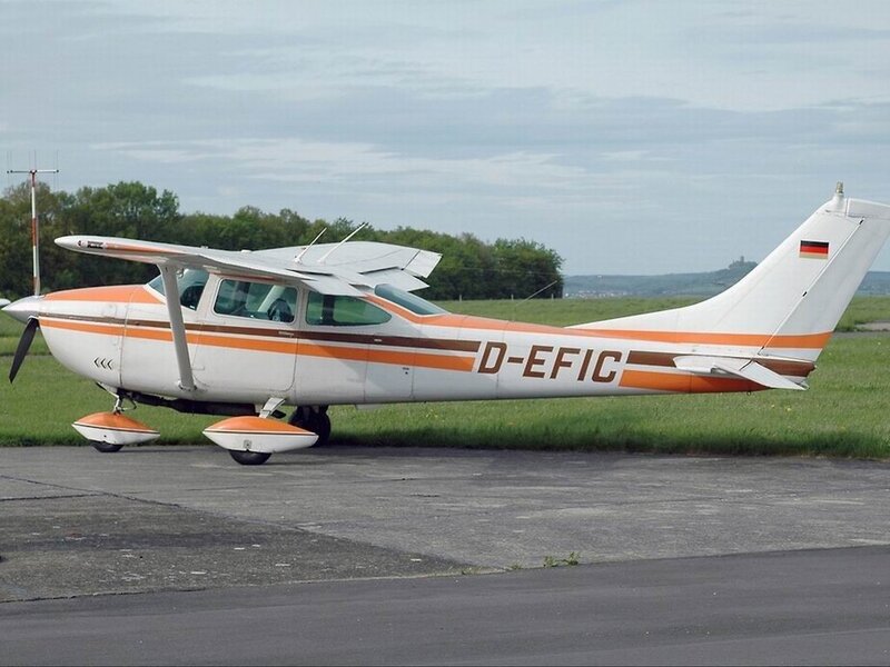 Orange and white airplane on tarmac