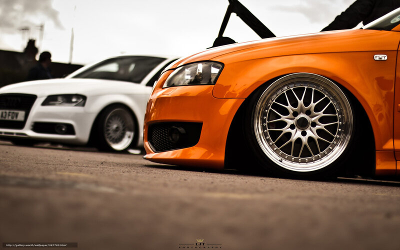 Orange and white Audi cars