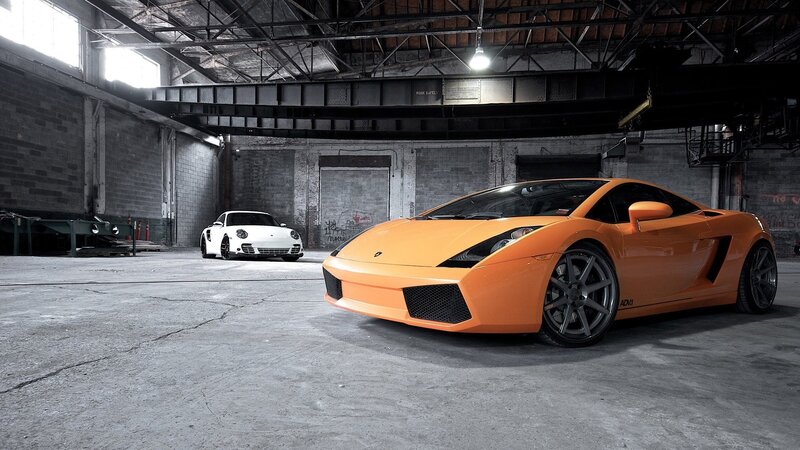 Orange and white sports cars in warehouse