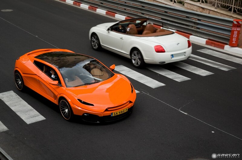 Orange and white sports cars on track