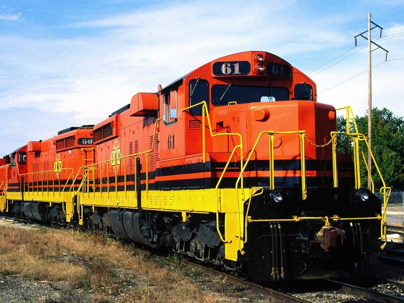 Orange and yellow locomotives on tracks