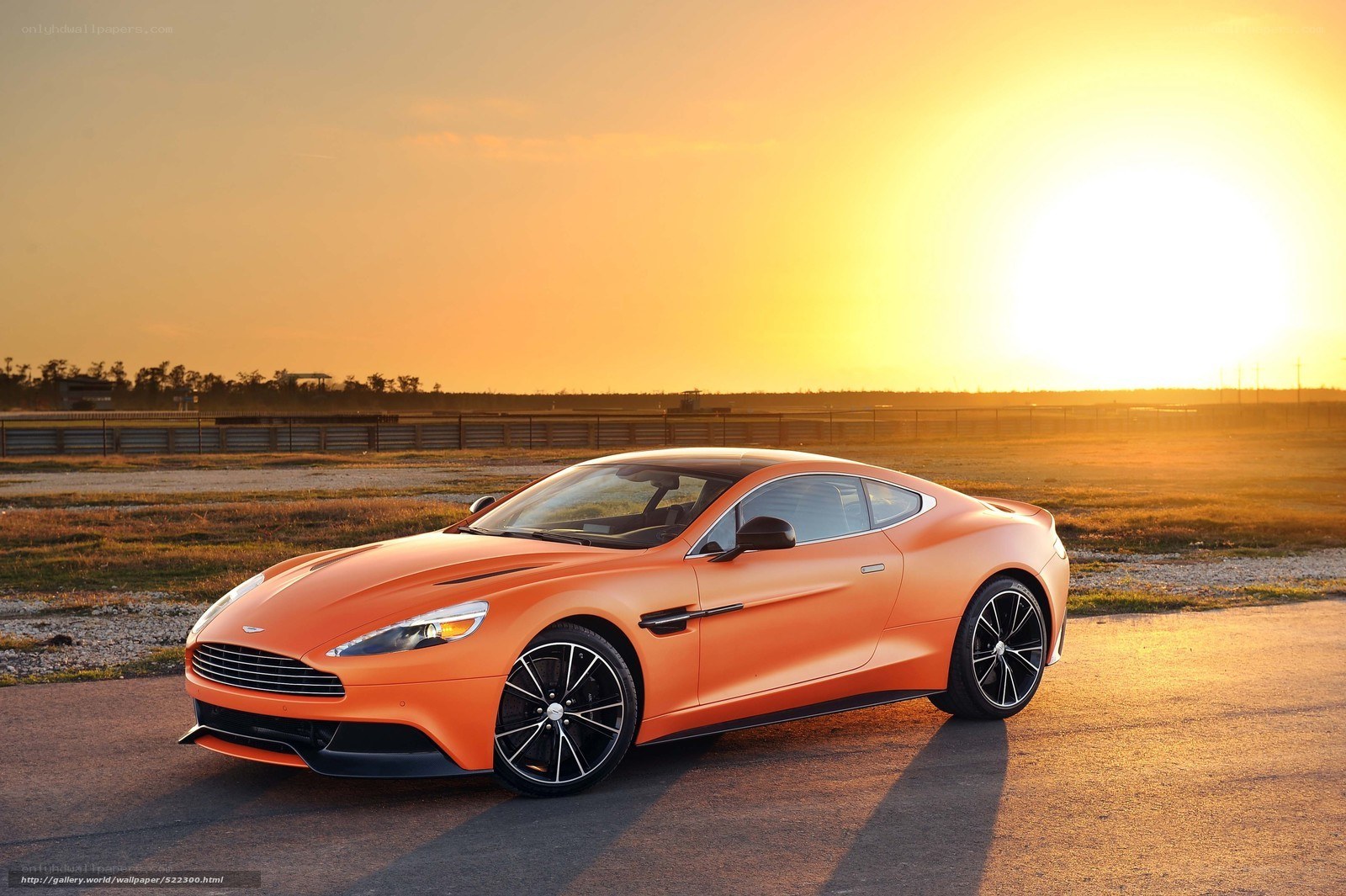 Orange Aston Martin at sunset