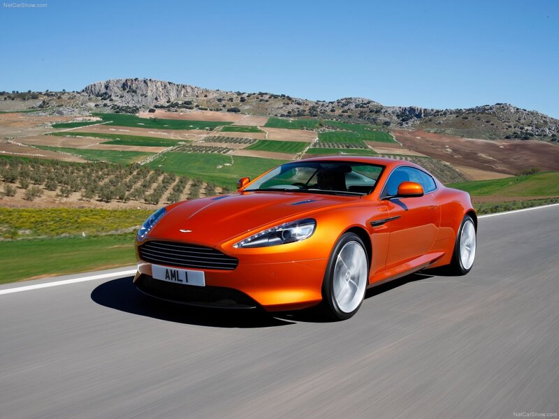 Orange Aston Martin on a country road