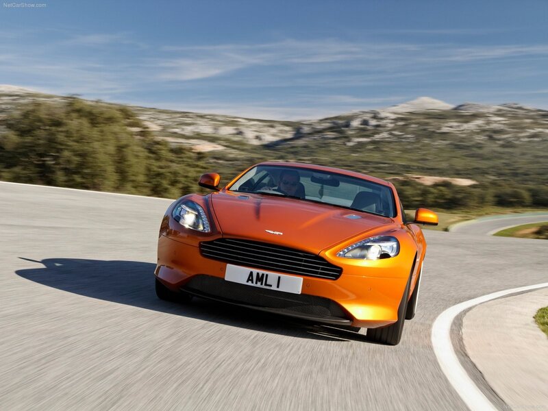 Orange Aston Martin on a winding road