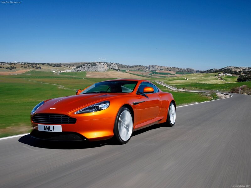 Orange Aston Martin on country road