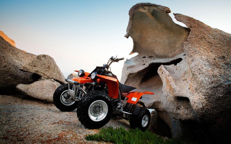 Orange ATV on rocky terrain