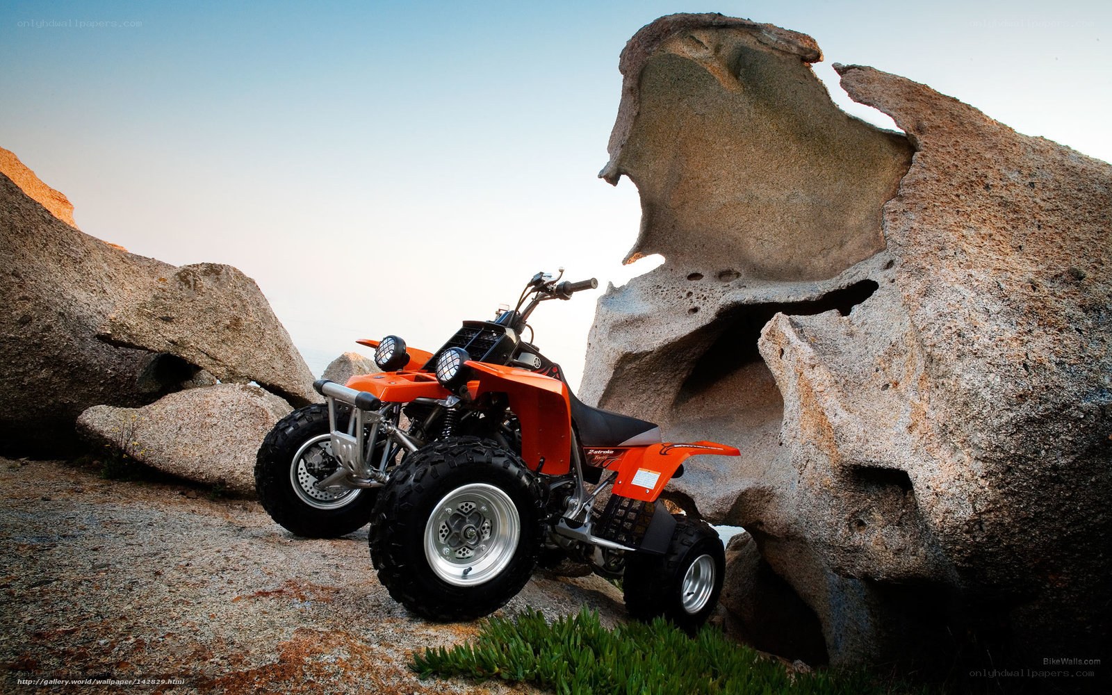Orange ATV on rocky terrain