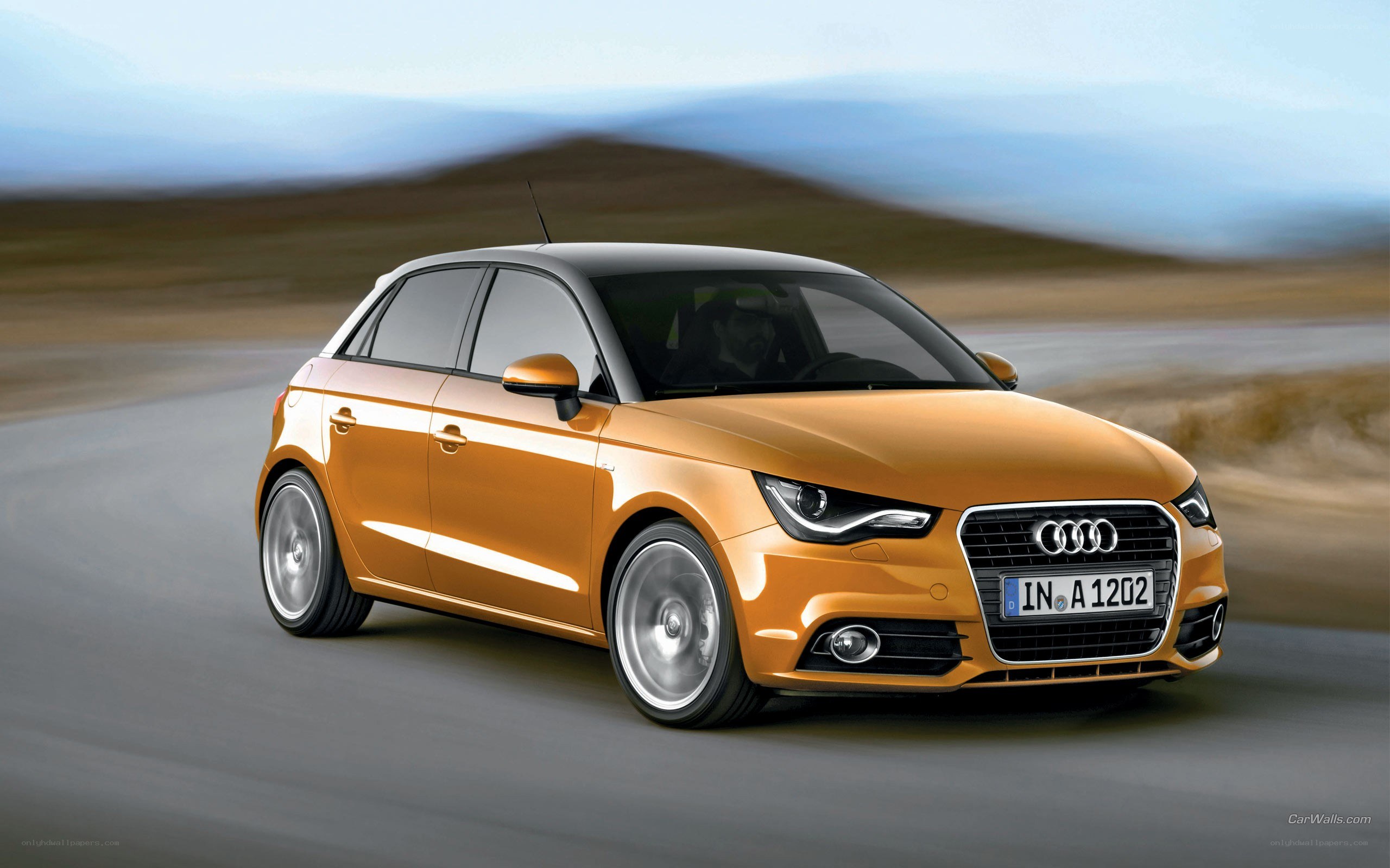 Orange Audi A1 in motion
