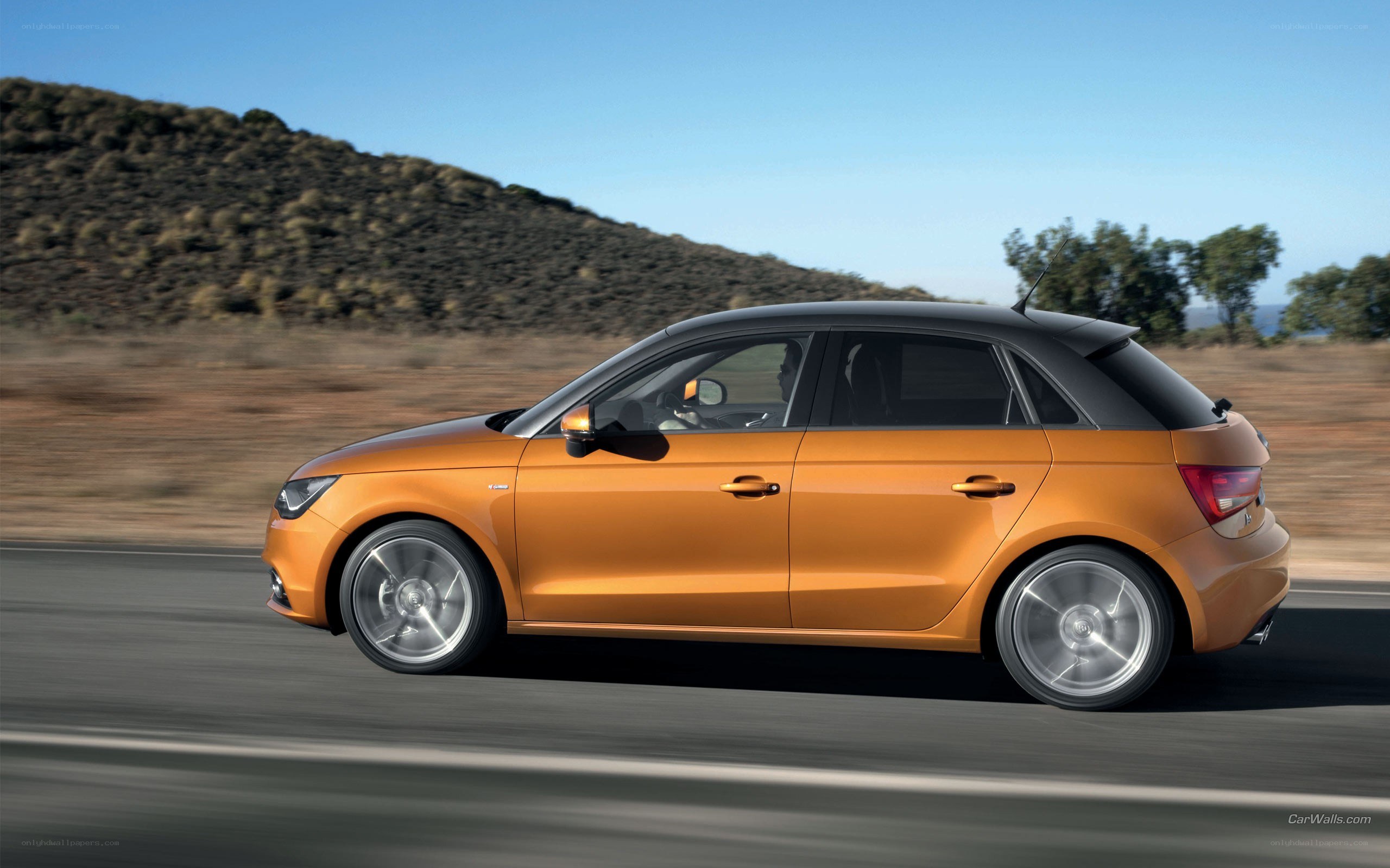 orange audi a1 in motion