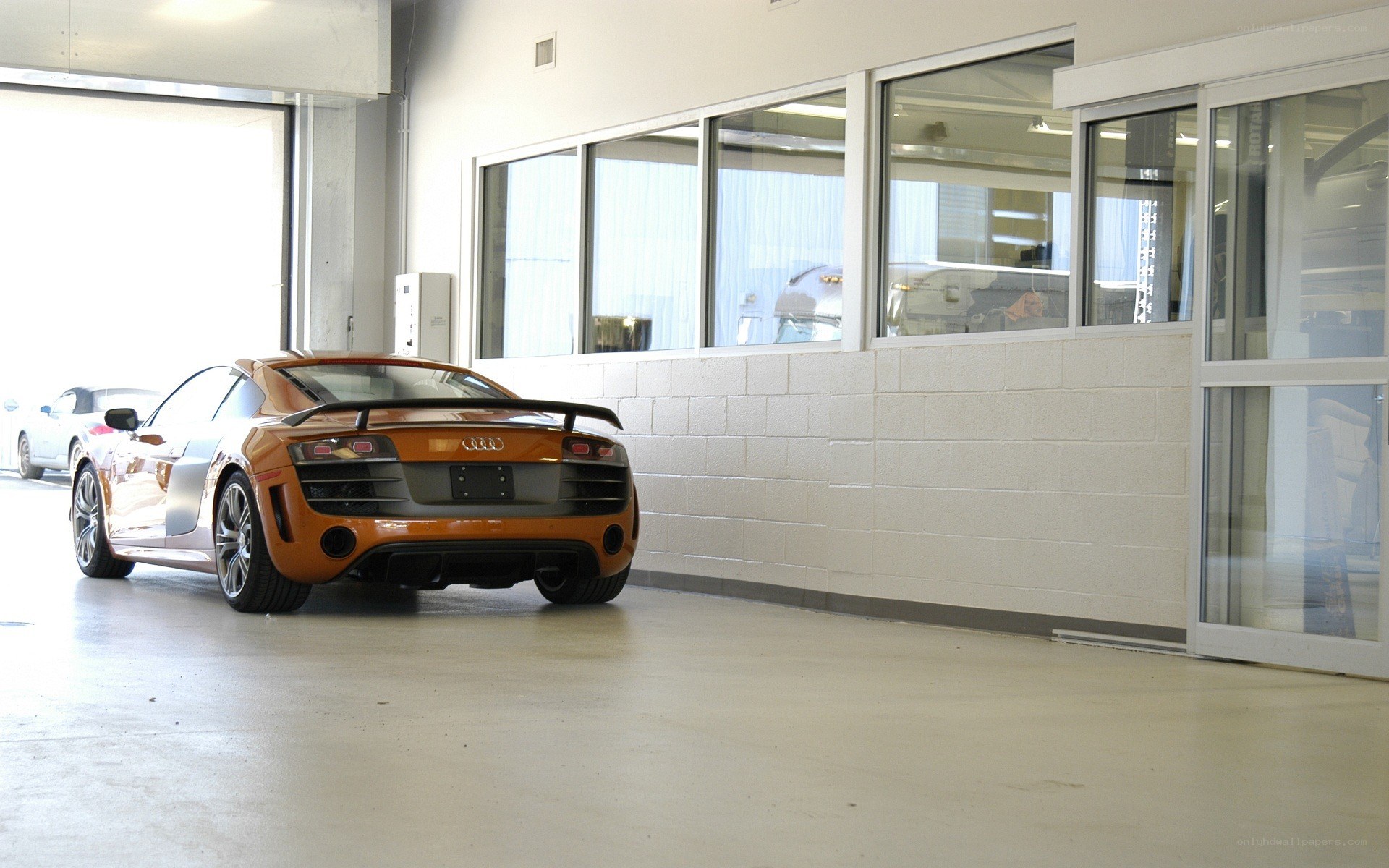 Orange Audi R8 in a garage