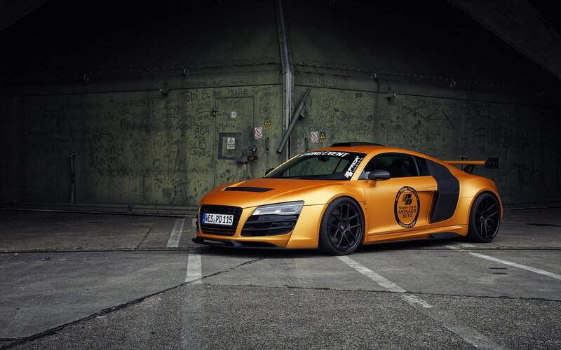 Orange Audi R8 in a graffiti tunnel