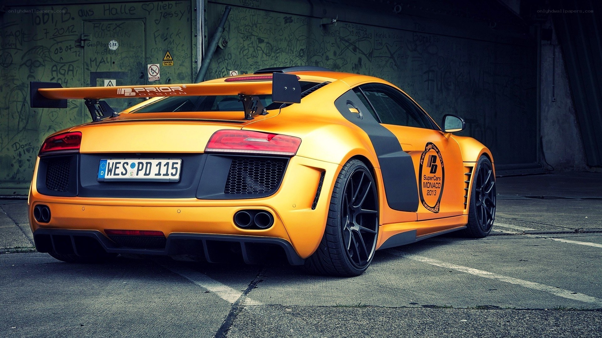 orange audi r8 with rear wing