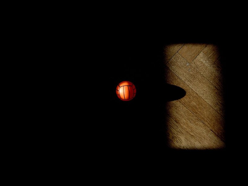 Orange ball on dark floor