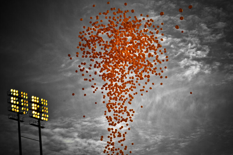 Orange balloons released at night