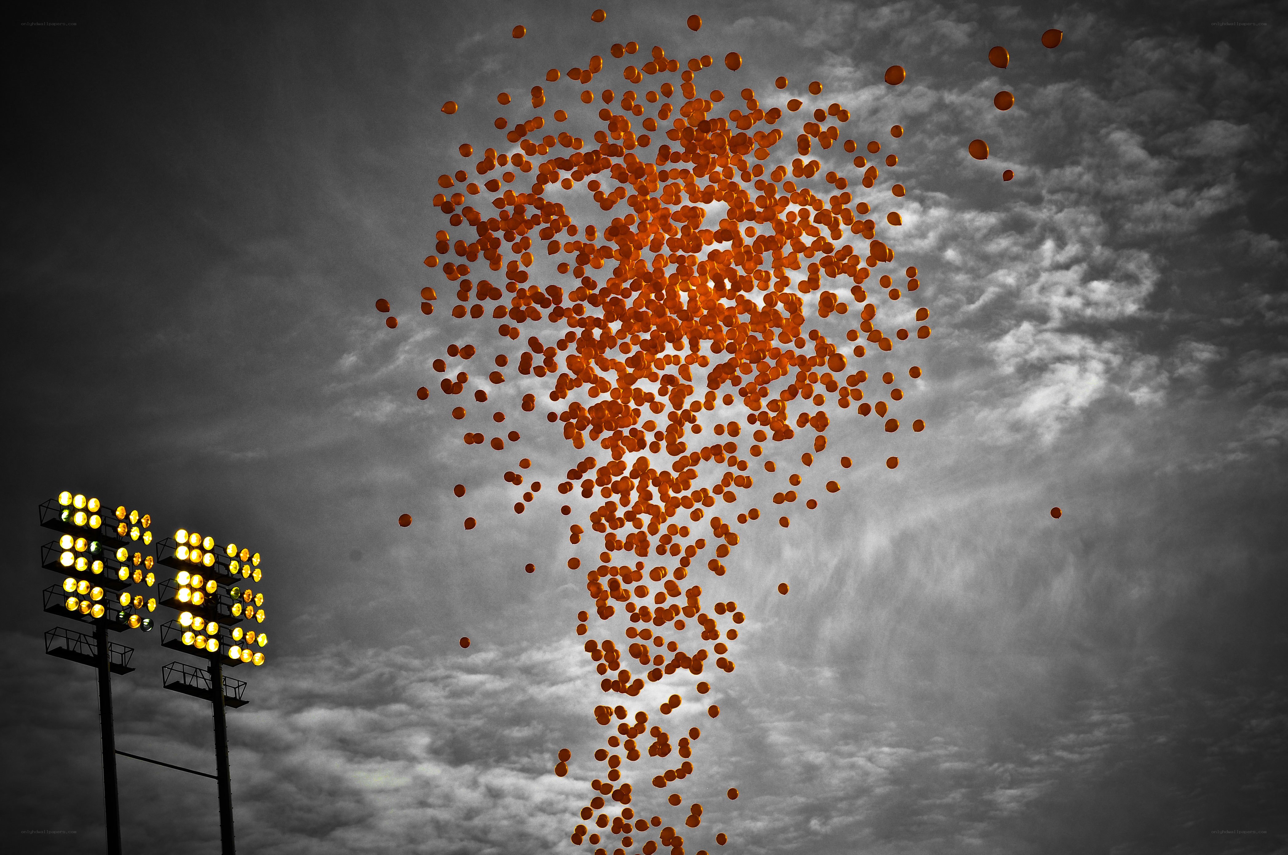 Orange balloons released at night