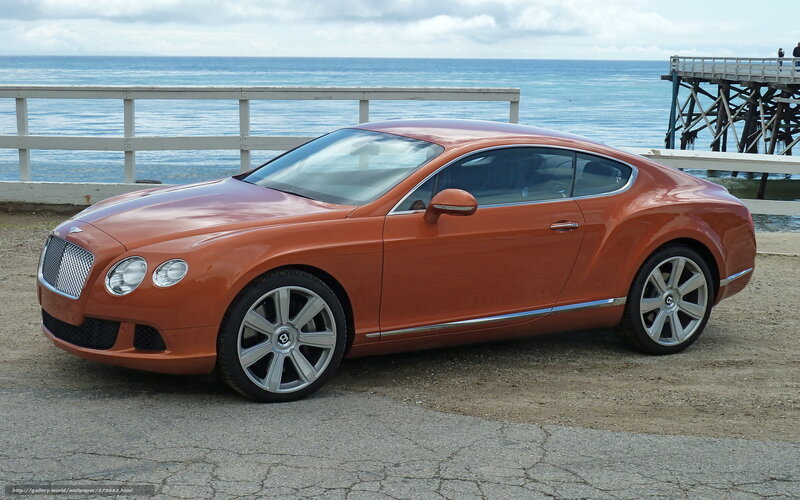 Orange Bentley near the ocean