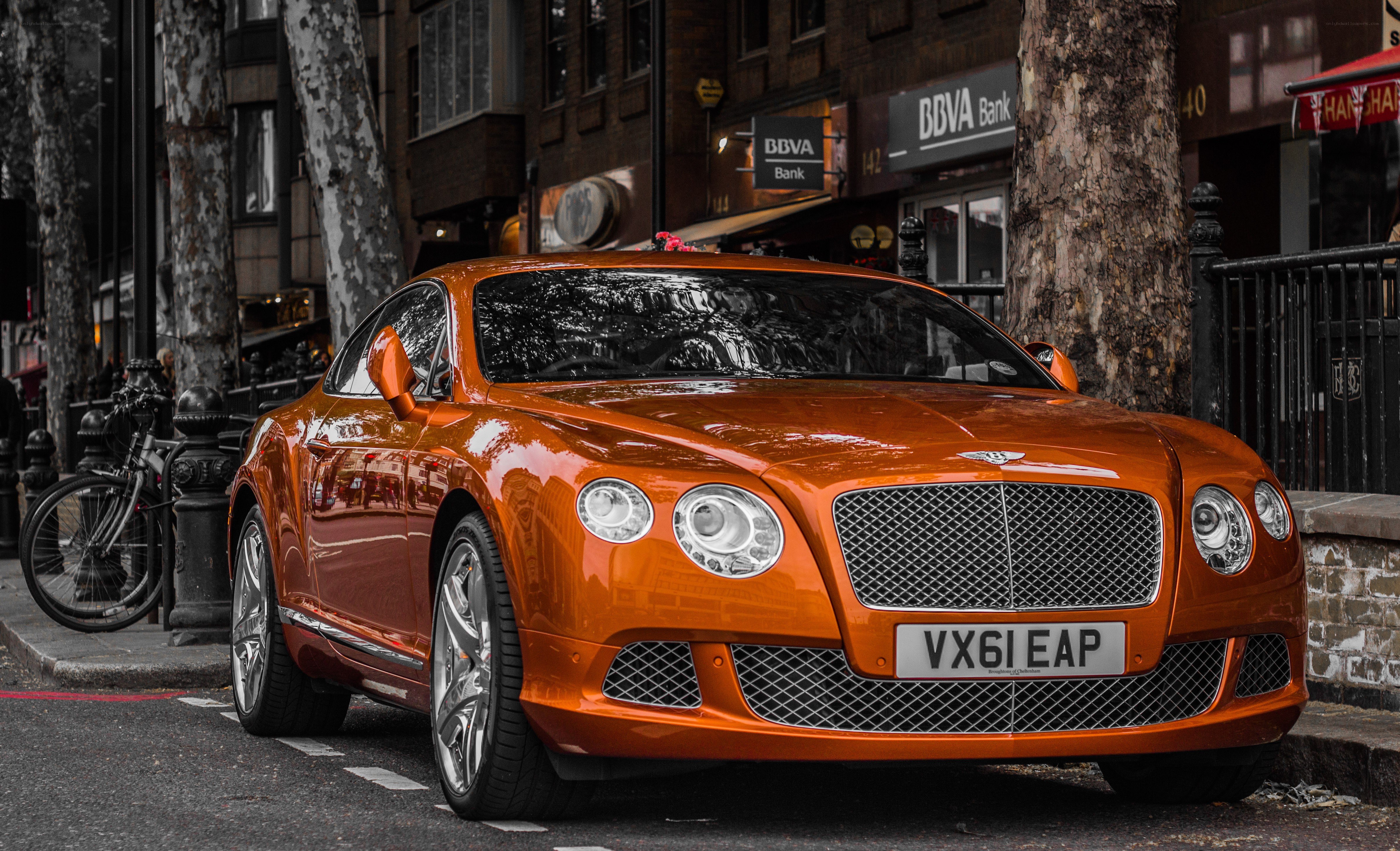 Orange Bentley on city street