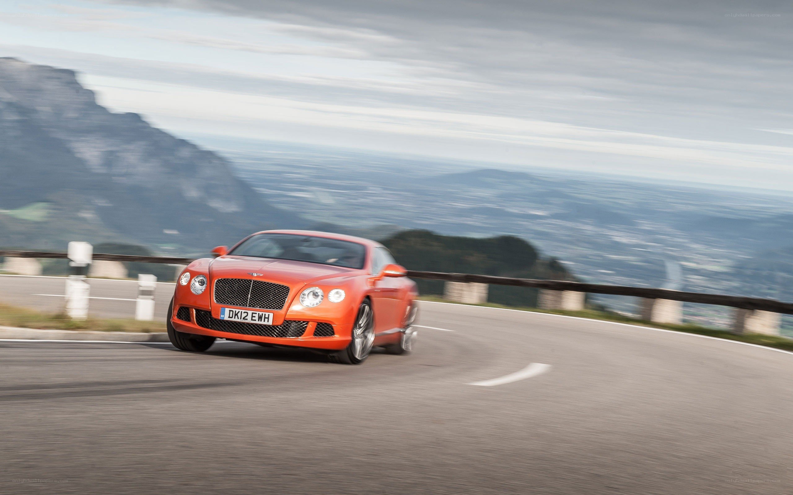 Orange Bentley on mountain road